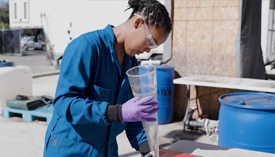 Stanford undergraduate Julia Simon collects wastewater from the Codiga Resource Recovery Center at Stanford for analysis. | Image by Harry Gregory